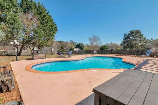 a view of a swimming pool with a yard
