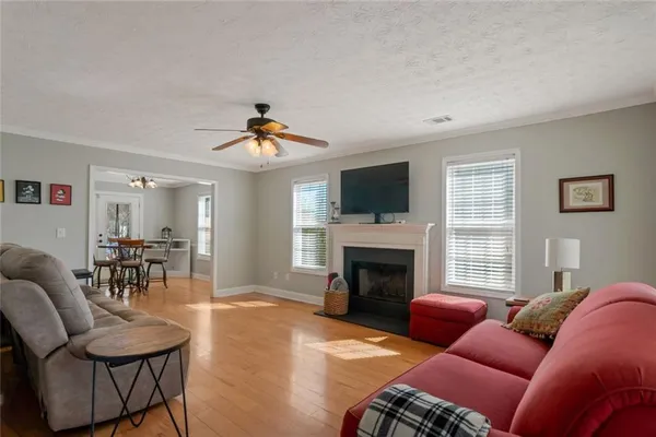 a living room with furniture a fireplace and a flat screen tv