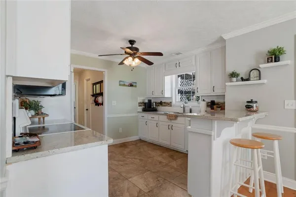 a kitchen with cabinets a sink and appliances