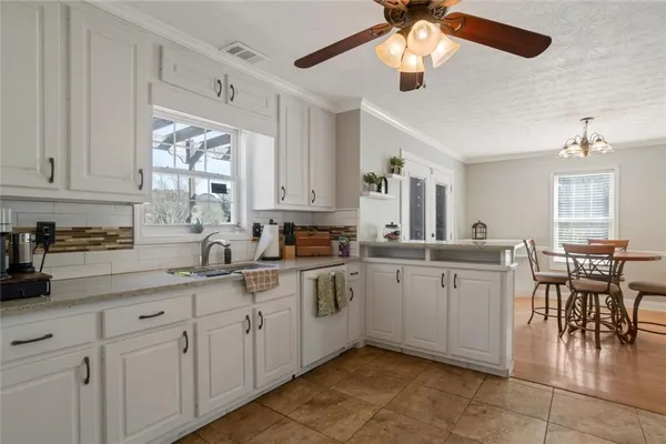 a kitchen with cabinets appliances and a window