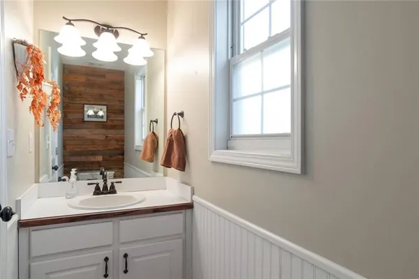 a bathroom with a sink vanity and a mirror