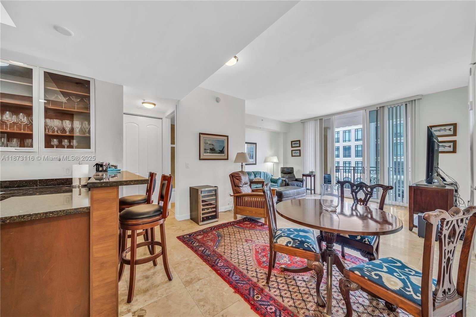 1607 Ponce De Leon, Unit 10C Coral Gables, FL 33134 - Photo 3 of 19 a living room with fireplace furniture and a table