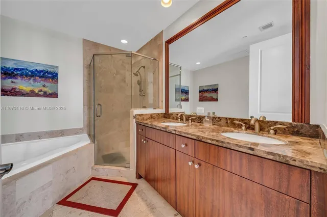 a bathroom with a granite countertop sink mirror toilet and bathtub
