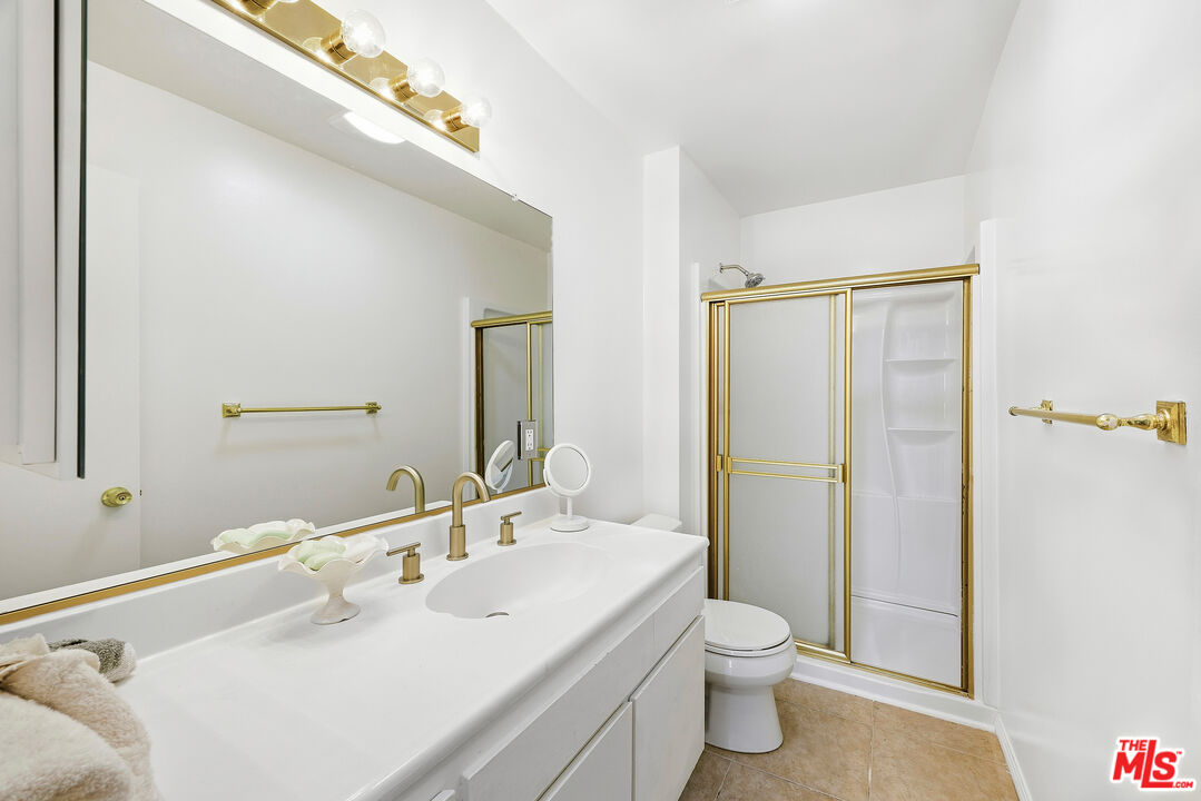 7740 Redlands Street, Unit G1095 Playa del Rey, CA 90293 - Photo 17 of 25 a bathroom with a toilet a sink and a large mirror