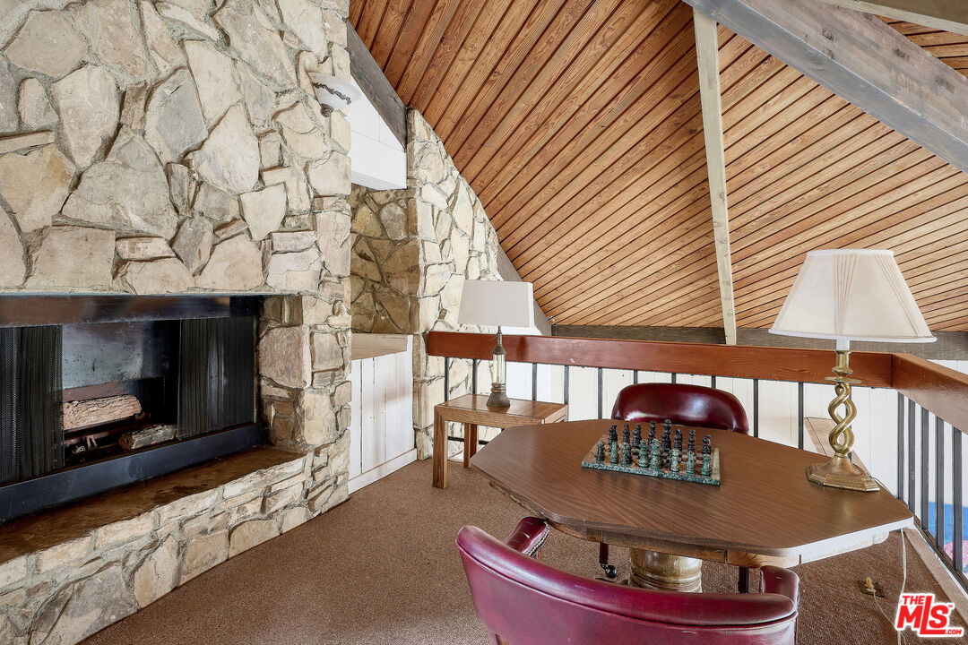 7740 Redlands Street, Unit G1095 Playa del Rey, CA 90293 - Photo 22 of 25 a living room with a fireplace and a table