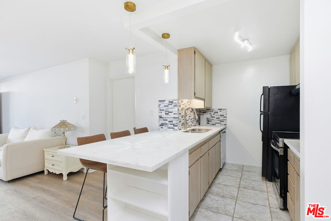 7740 Redlands Street, Unit G1095 Playa del Rey, CA 90293 - Photo 4 of 25 a kitchen with a sink and refrigerator