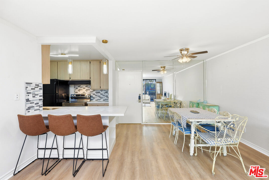 7740 Redlands Street, Unit G1095 Playa del Rey, CA 90293 - Photo 5 of 25 a view of a dining room with furniture and wooden floor