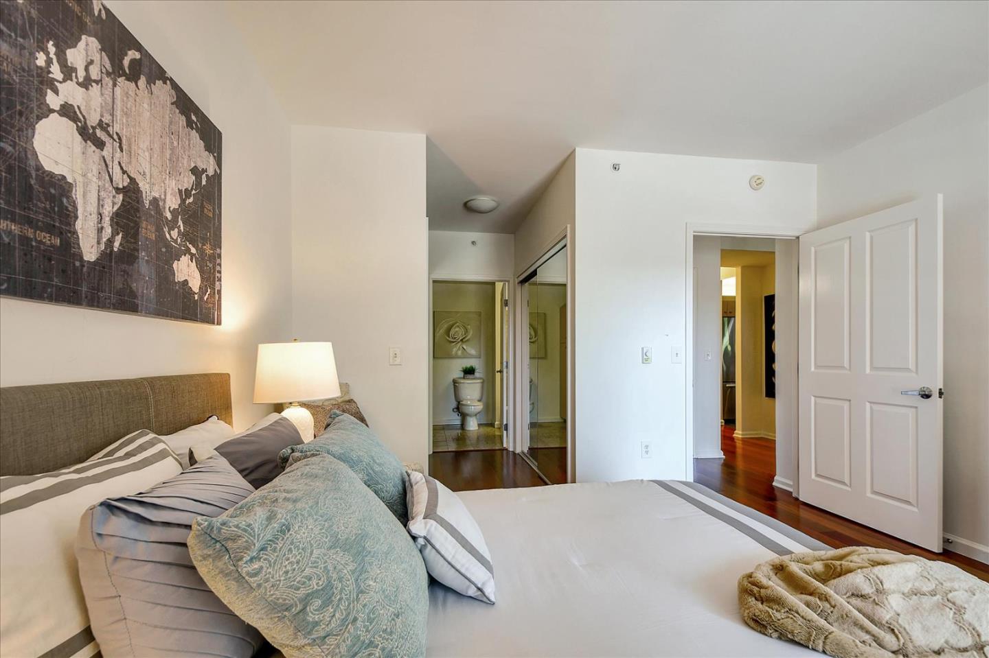 140 South Van Ness Avenue, Unit 422 San Francisco, CA 94103 - Photo 11 of 32 a bedroom with a bed and a mirror