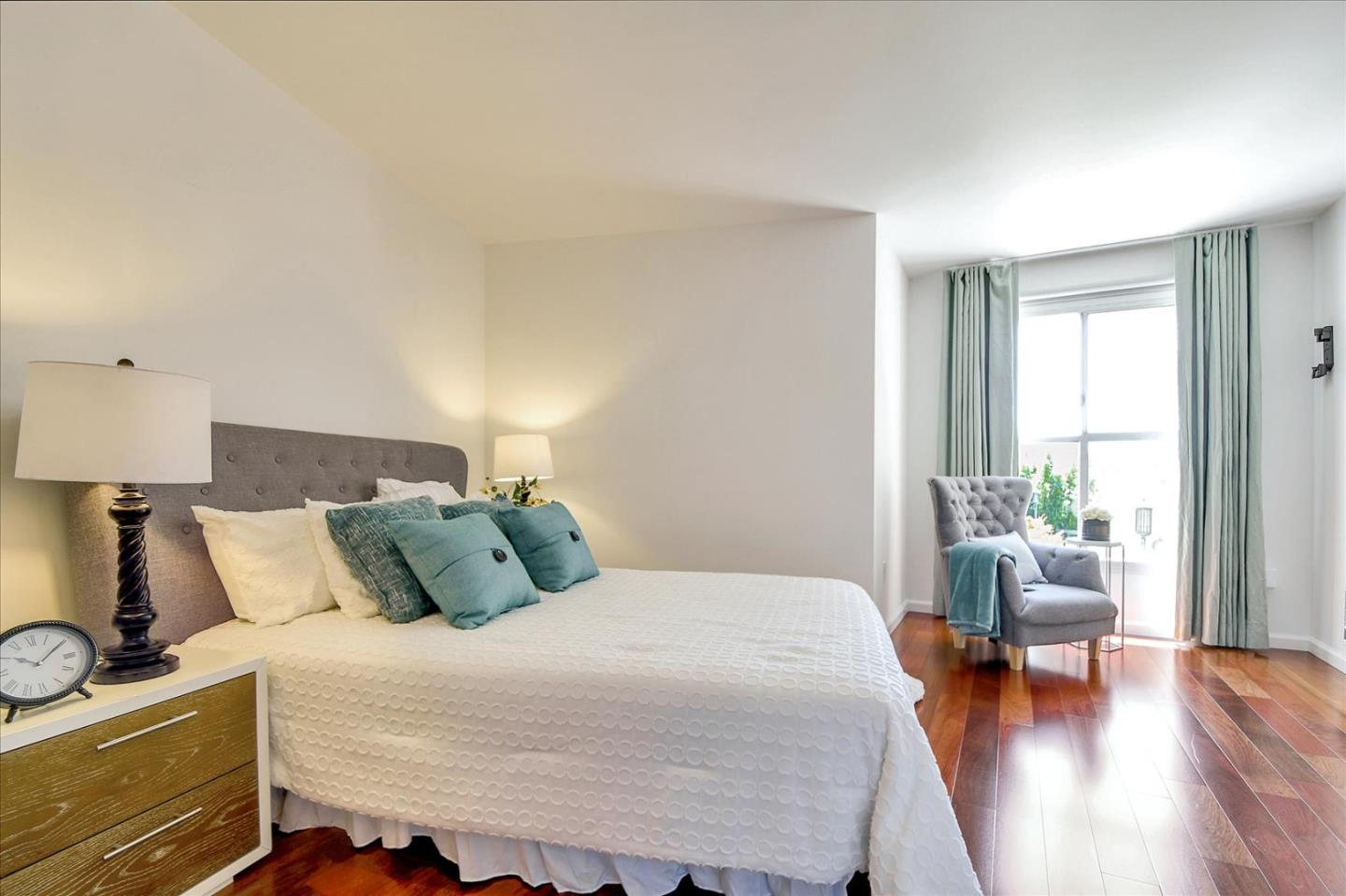 140 South Van Ness Avenue, Unit 422 San Francisco, CA 94103 - Photo 13 of 32 a bedroom with bed and wooden floor