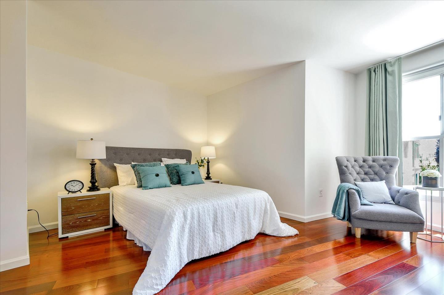 140 South Van Ness Avenue, Unit 422 San Francisco, CA 94103 - Photo 14 of 32 a bedroom with a bed and a chair