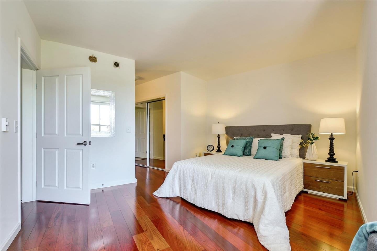 140 South Van Ness Avenue, Unit 422 San Francisco, CA 94103 - Photo 15 of 32 a bedroom with a bed and wooden floor