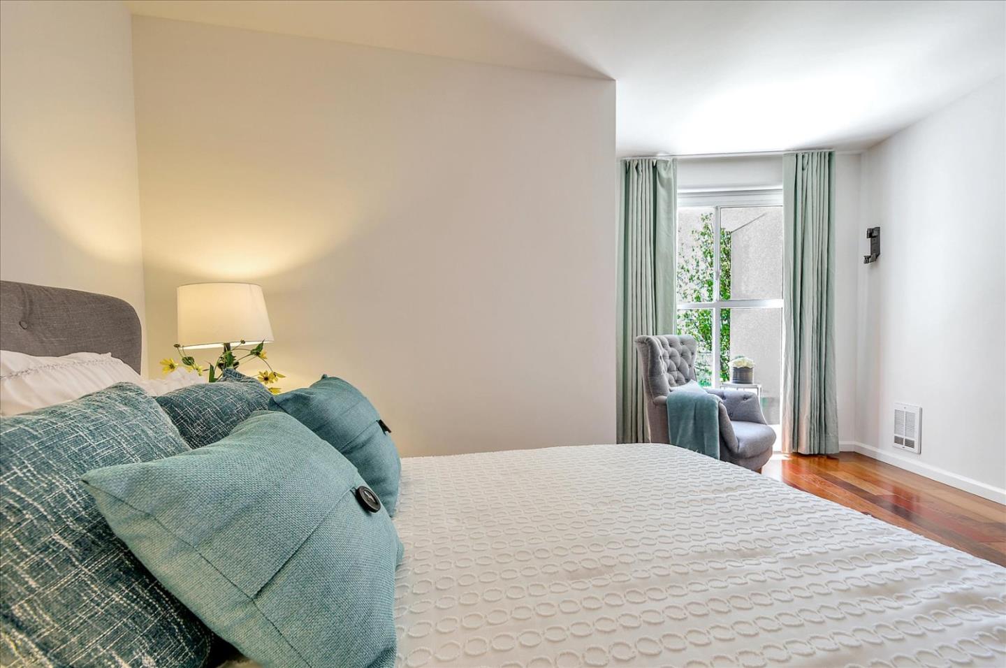 140 South Van Ness Avenue, Unit 422 San Francisco, CA 94103 - Photo 16 of 32 a bedroom with a bed and a window