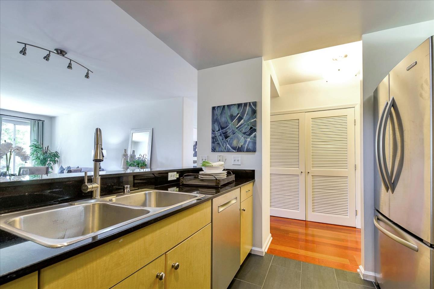 140 South Van Ness Avenue, Unit 422 San Francisco, CA 94103 - Photo 6 of 32 a kitchen with granite countertop a sink and a refrigerator
