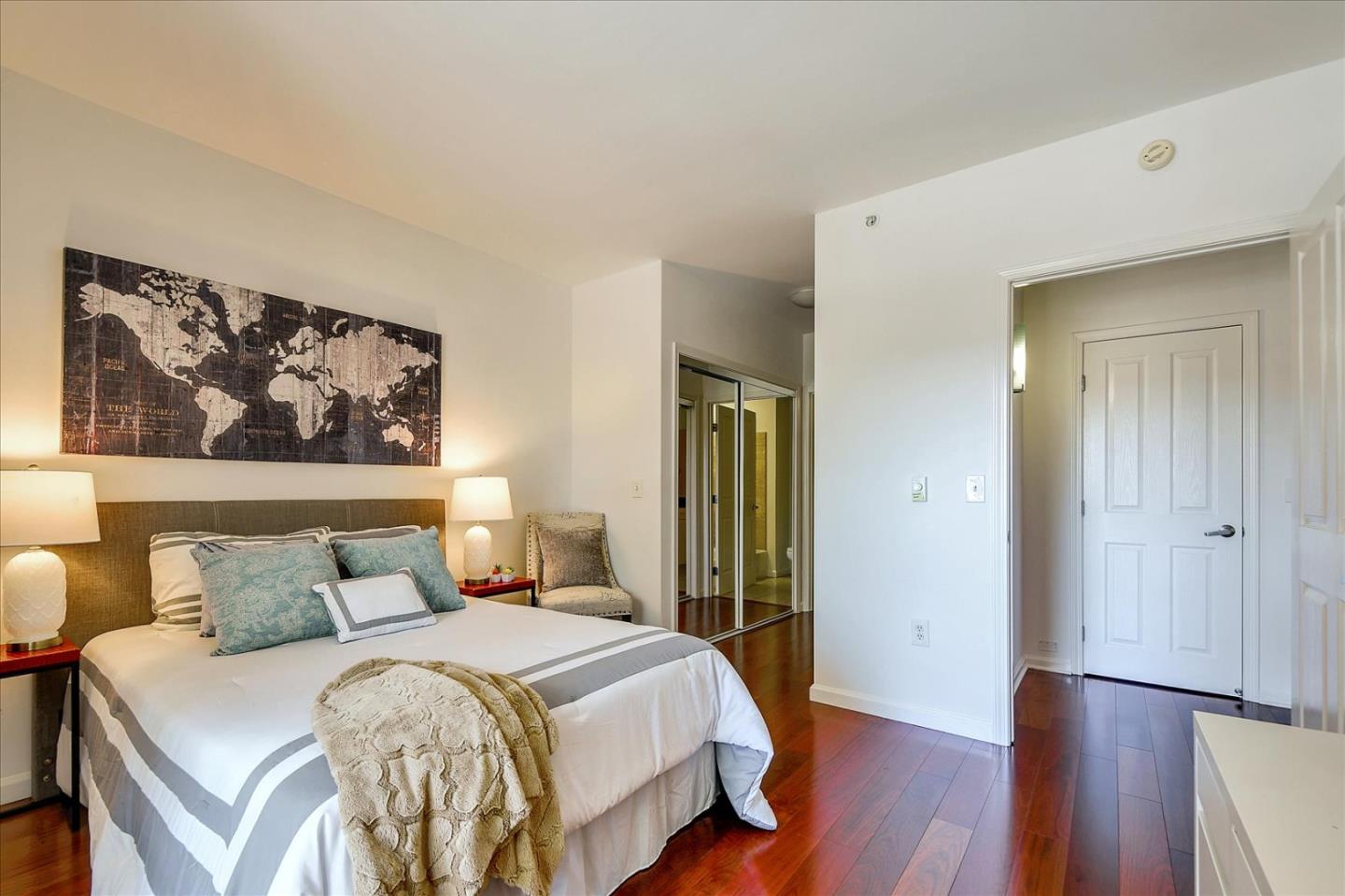 140 South Van Ness Avenue, Unit 422 San Francisco, CA 94103 - Photo 9 of 32 a bedroom with a bed and wooden floor