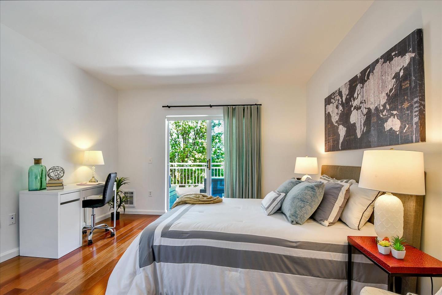 140 South Van Ness Avenue, Unit 422 San Francisco, CA 94103 - Photo 10 of 32 a bedroom with a bed and large windows