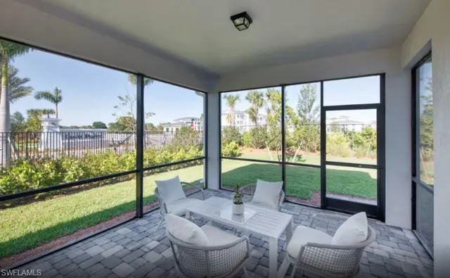 a living room with couch and a floor to ceiling window