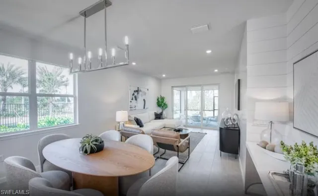 a living room with furniture and a chandelier