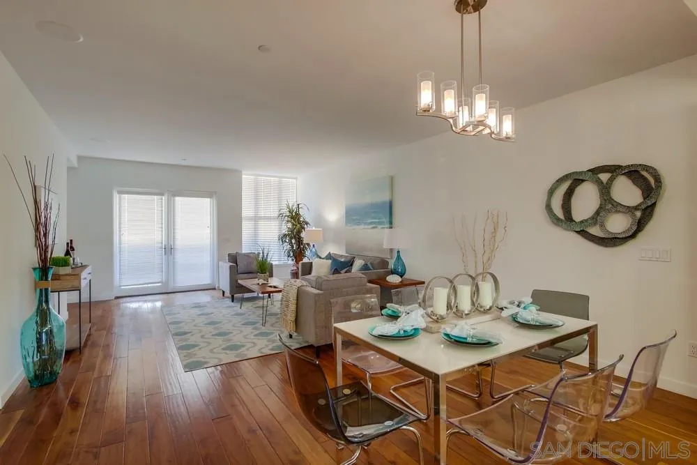 90 North Coast Highway 101, Unit 312 Encinitas, CA 92024 - Photo 11 of 19 a view of a dining room with furniture wooden floor and chandelier