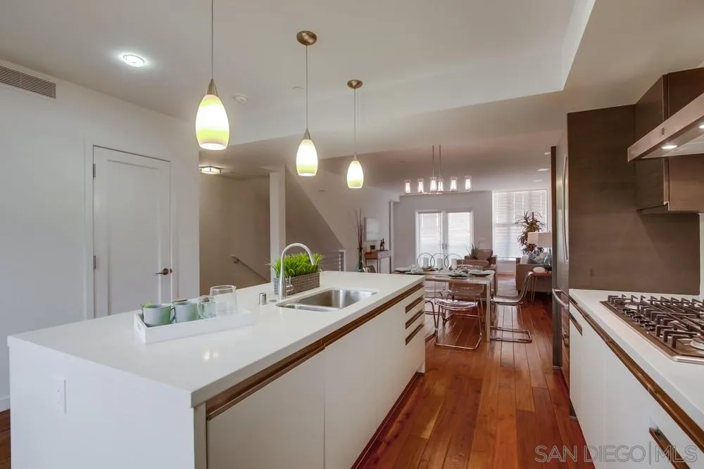 90 North Coast Highway 101, Unit 312 Encinitas, CA 92024 - Photo 12 of 19 a large kitchen with a table and chairs