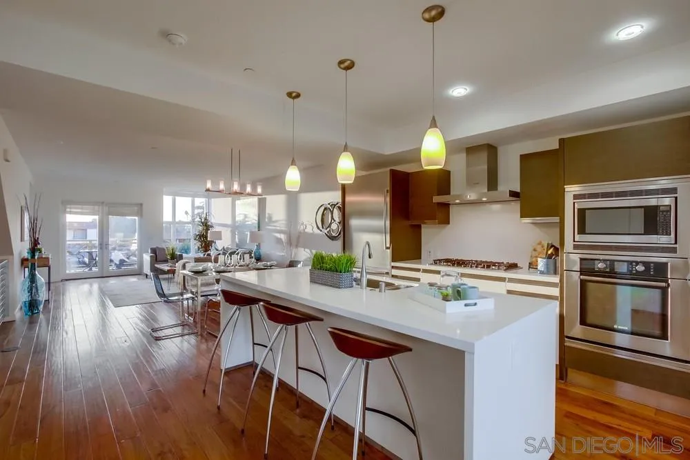 90 North Coast Highway 101, Unit 312 Encinitas, CA 92024 - Photo 13 of 19 a kitchen with lots of counter top space and wooden floor