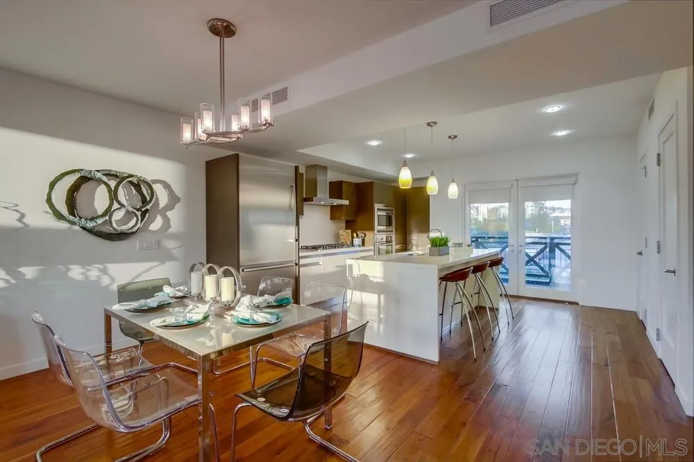 90 North Coast Highway 101, Unit 312 Encinitas, CA 92024 - Photo 16 of 19 a view of a dining room and livingroom with furniture wooden floor a chandelier