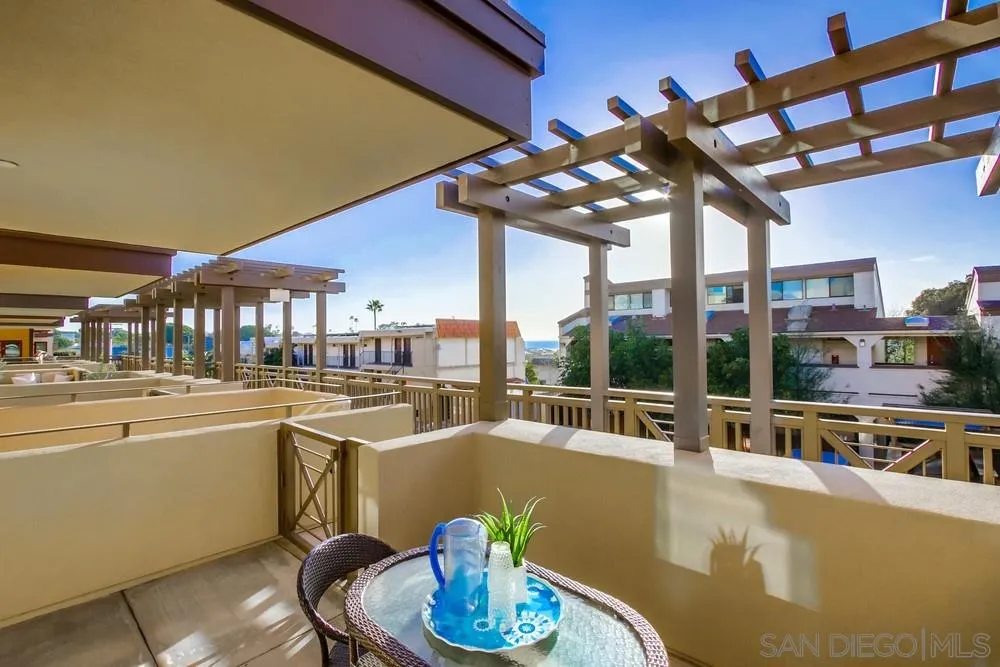 90 North Coast Highway 101, Unit 312 Encinitas, CA 92024 - Photo 17 of 19 a dining room with furniture a floor to ceiling window and outdoor view