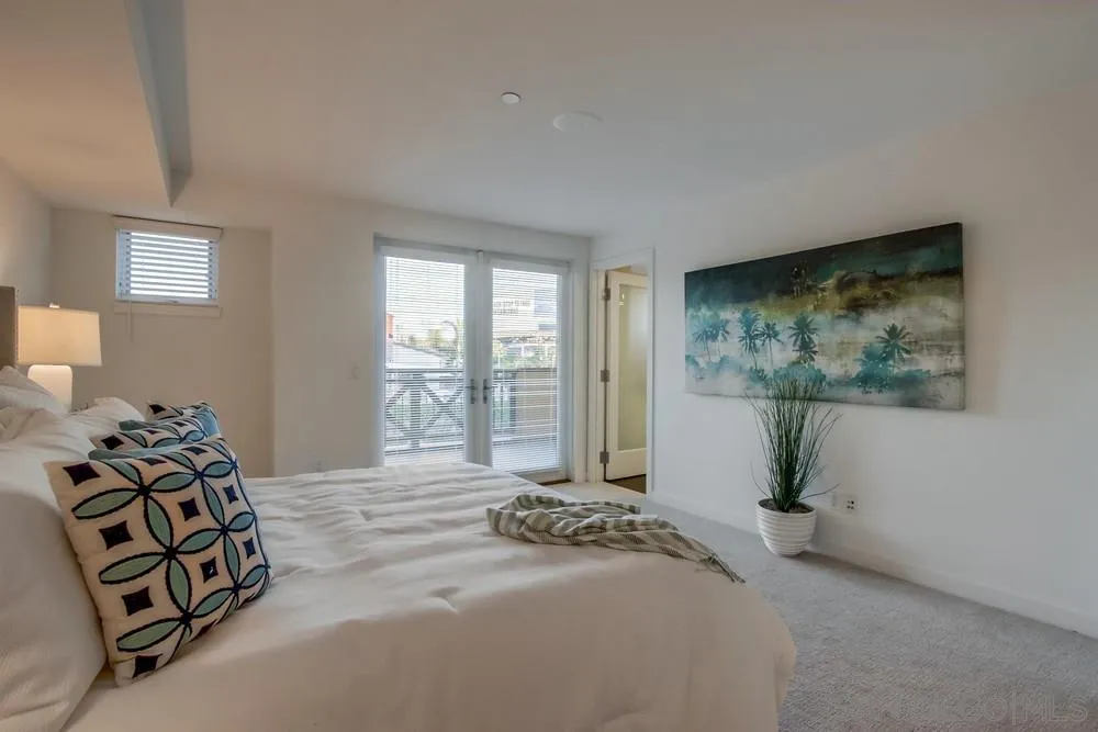 90 North Coast Highway 101, Unit 312 Encinitas, CA 92024 - Photo 7 of 19 a spacious bedroom with a bed and a large window