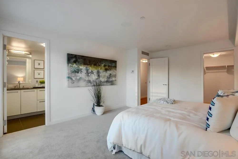 90 North Coast Highway 101, Unit 312 Encinitas, CA 92024 - Photo 8 of 19 a bedroom with a bed and a painting on the wall