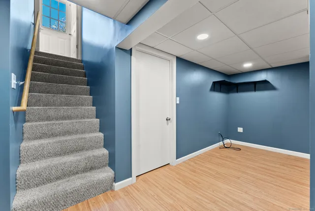 a view of an empty room with stairs and ventilation