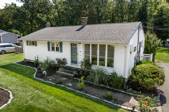 a view of a house with a yard and plants