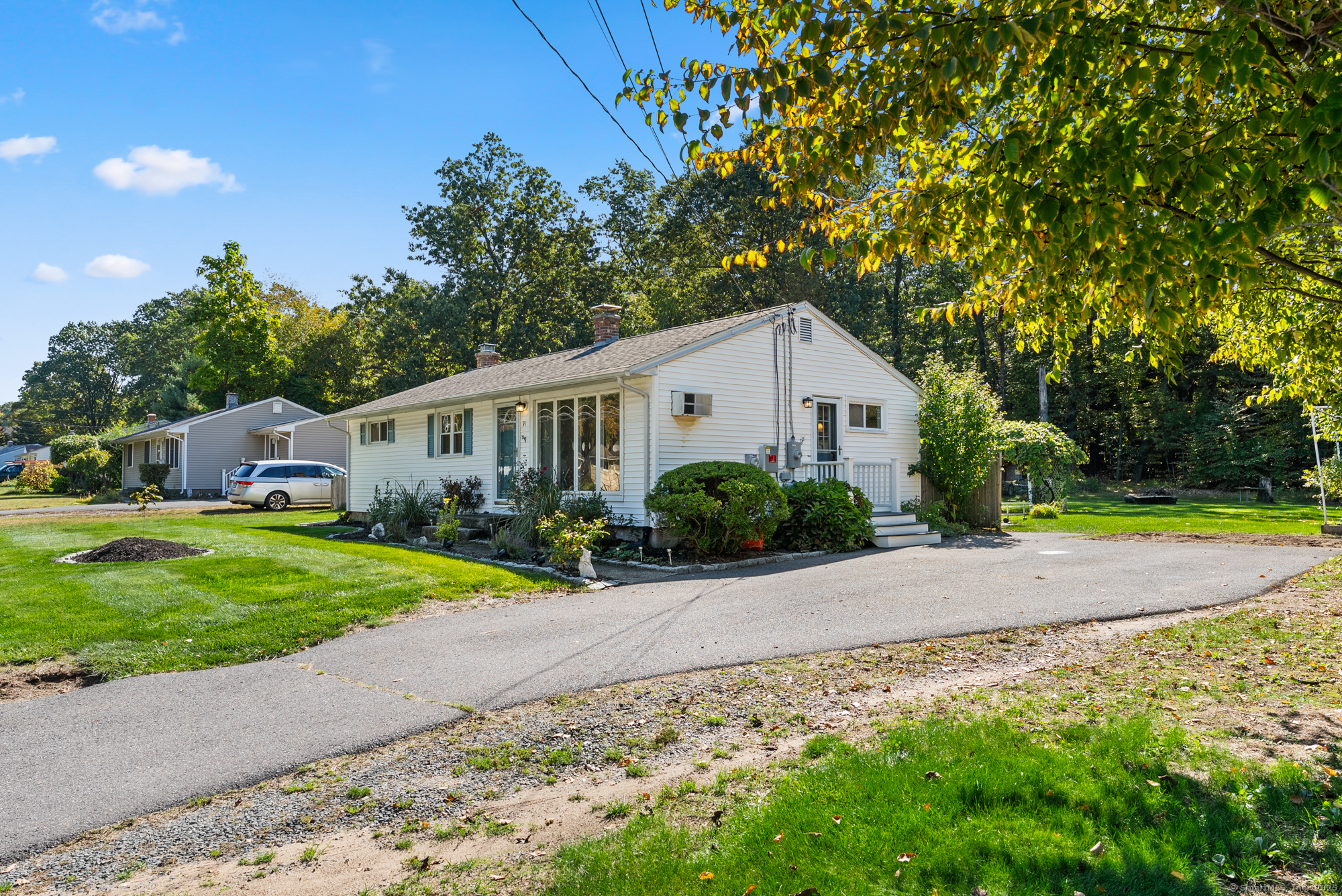 91 Till Street Enfield, CT 06082 - Photo 19 of 30 a front view of a house with a yard and garage