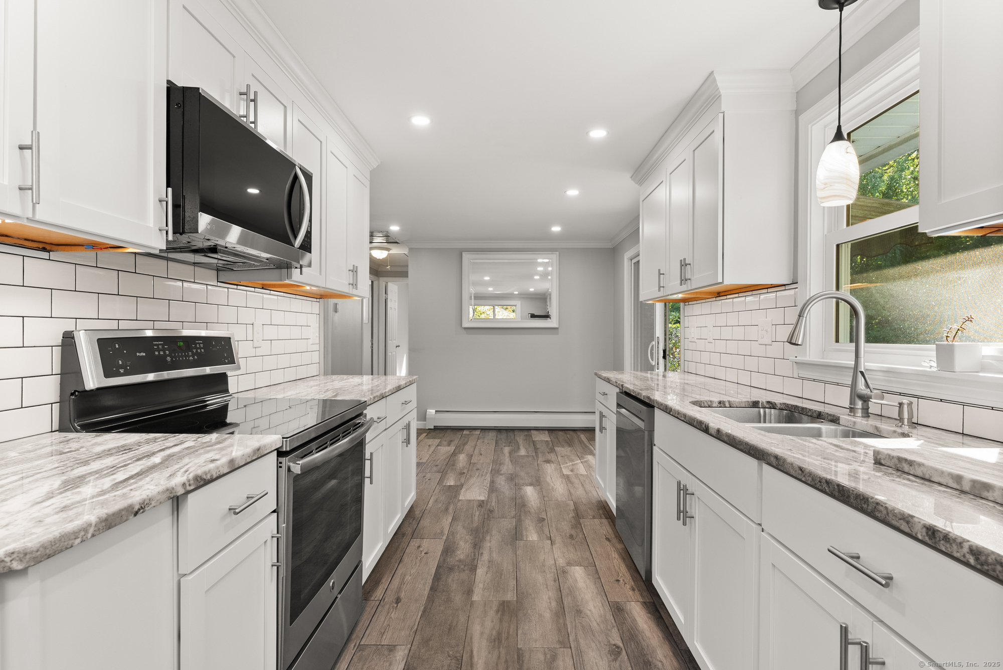 91 Till Street Enfield, CT 06082 - Photo 2 of 30 a kitchen with stainless steel appliances wooden cabinets granite counter tops and a stove