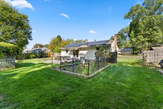 a view of a house with a yard porch and sitting area