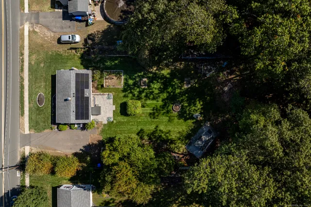 an aerial view of a house with a yard
