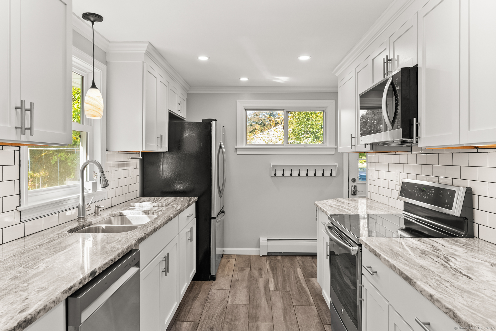 91 Till Street Enfield, CT 06082 - Photo 4 of 30 a kitchen with stainless steel appliances granite countertop a sink stove and refrigerator