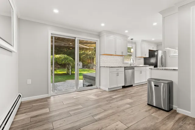 a kitchen with kitchen island a sink appliances and cabinets