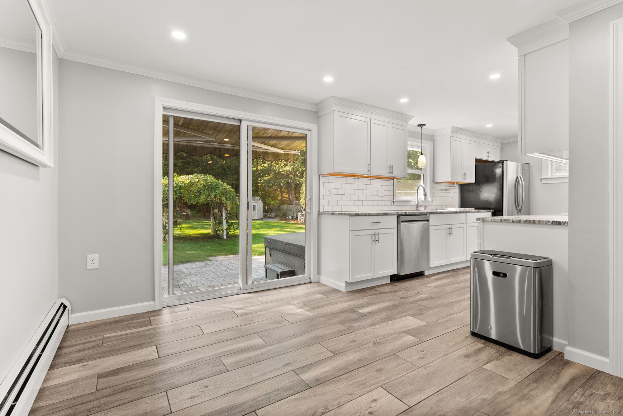 91 Till Street Enfield, CT 06082 - Photo 6 of 30 a kitchen with kitchen island a sink appliances and cabinets