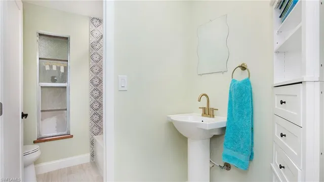 a bathroom with a toilet and a shower curtain