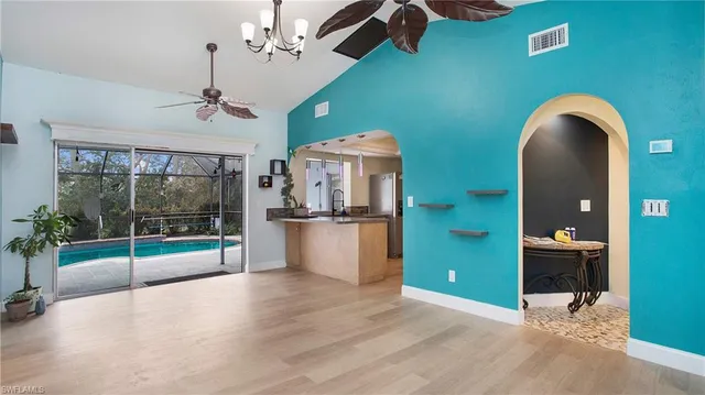 a kitchen with stainless steel appliances granite countertop a sink and a refrigerator