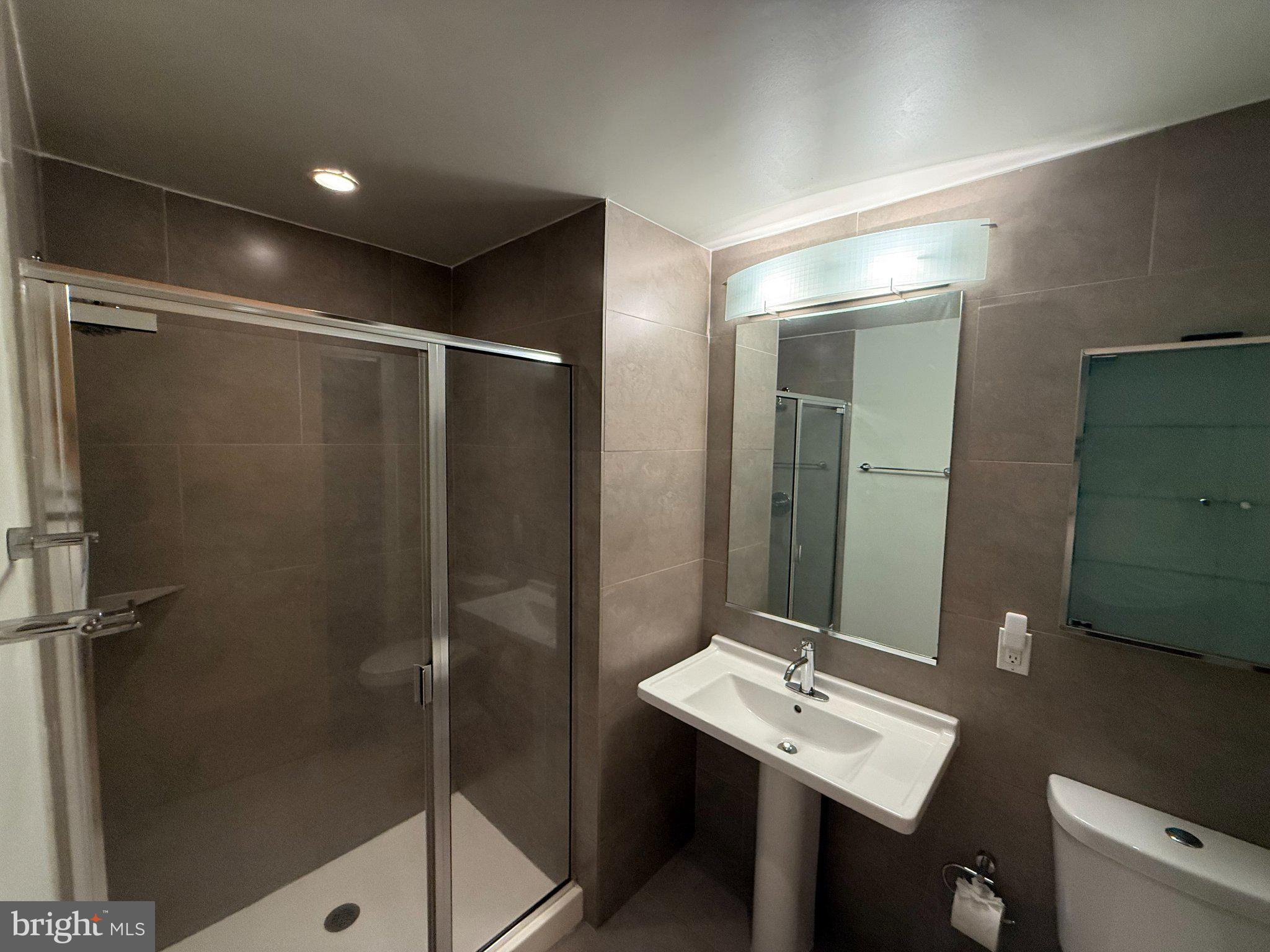 1133 14th Street Northwest, Unit 503 Washington, DC 20005 - Photo 15 of 29 Sleek modern bathroom with elegant tiles.