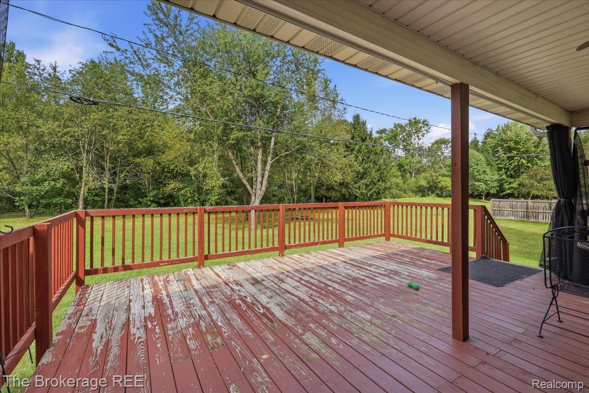 11282 Silver Lake Road Byron, MI 48418 - Photo 29 of 32 Expansive wood deck with full railing and steps to a grassy yard