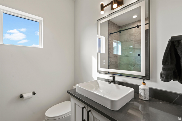 4499 North Seven Bridges Road, Unit 9 Eden, UT 84310 - Photo 28 of 65 Floating vanity with a rectangular vessel sink, dark countertop, and matte black faucet