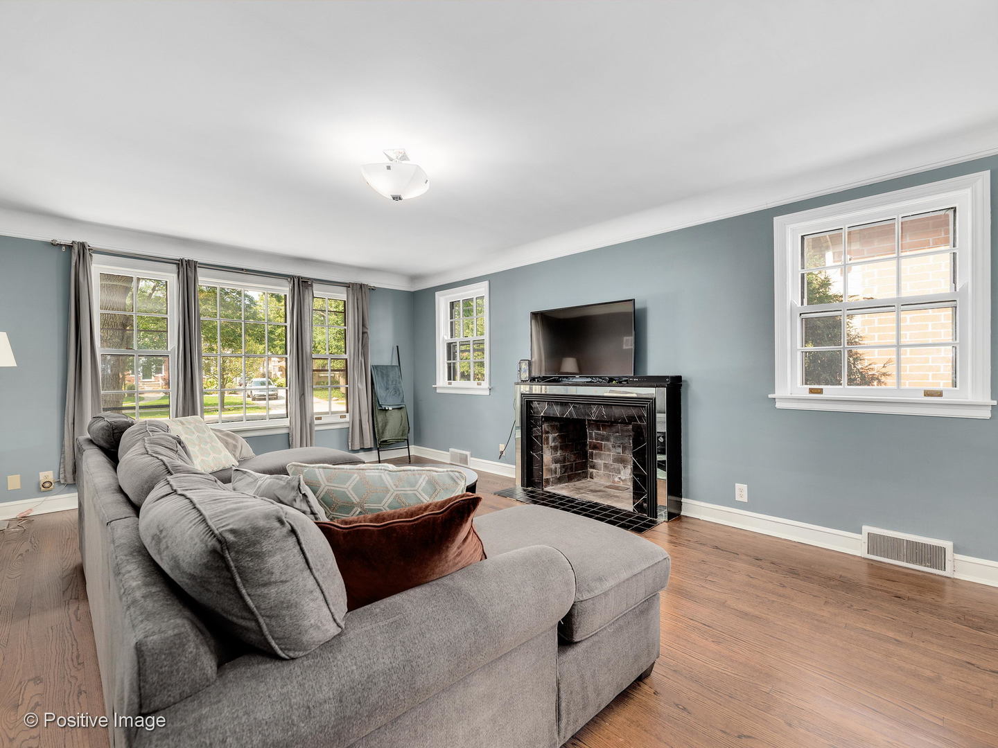 331 Selborne Road Riverside, IL 60546 - Photo 6 of 19 a living room with furniture a fireplace and a flat screen tv
