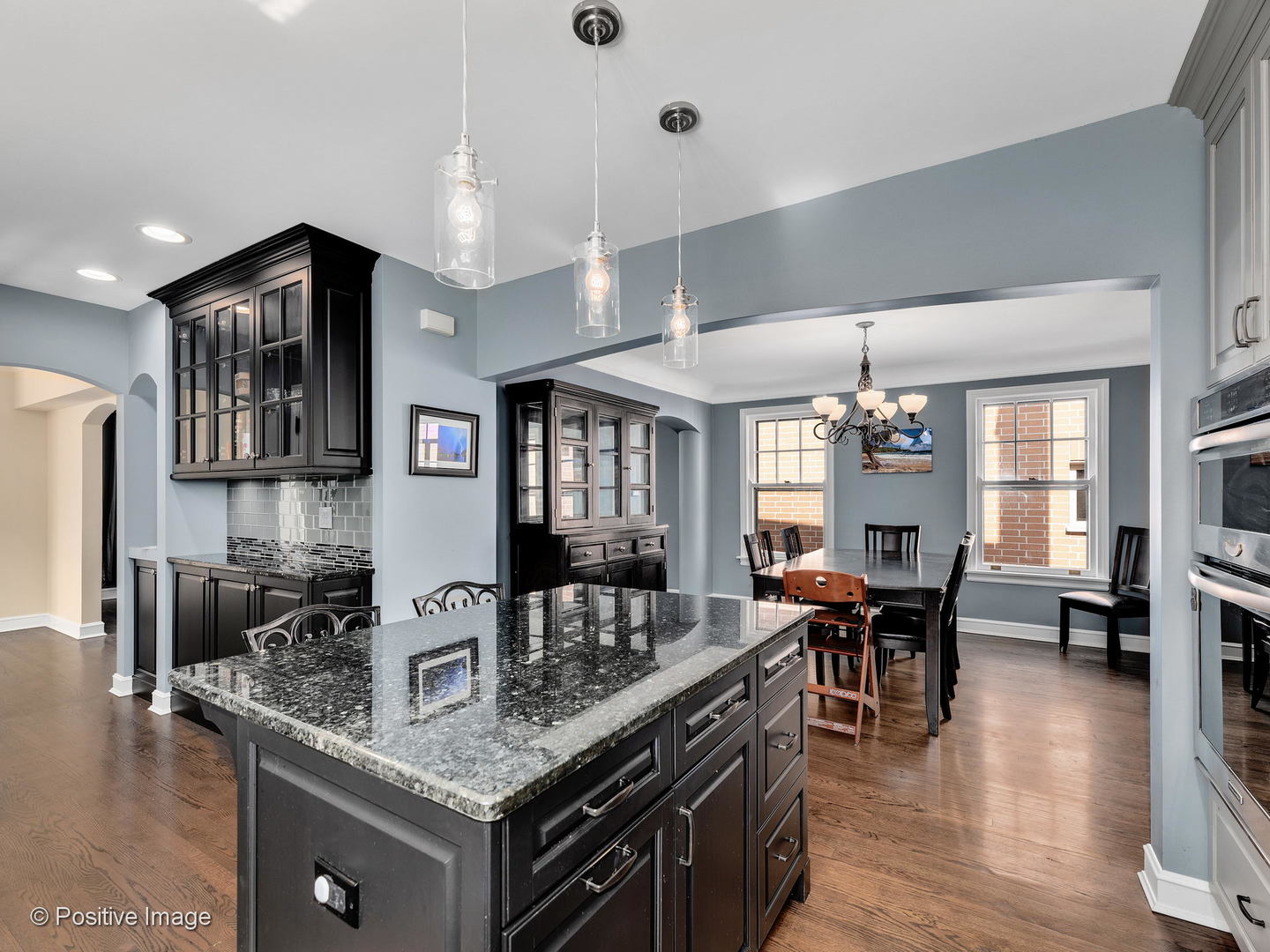 331 Selborne Road Riverside, IL 60546 - Photo 10 of 19 a kitchen with stainless steel appliances granite countertop a sink dishwasher a dining table and chairs with wooden floor