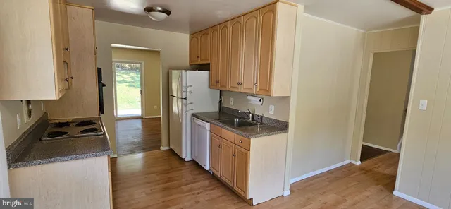 a kitchen with a stove a refrigerator and a sink