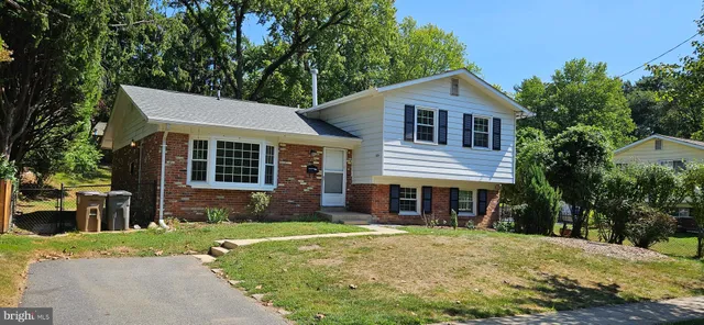 a front view of a house with a yard and porch