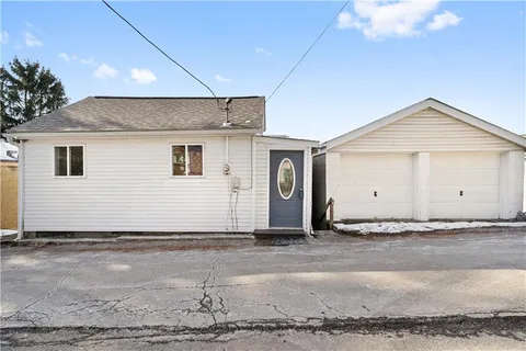a view of a house with a backyard