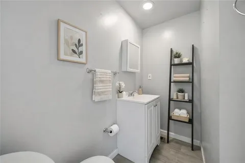 a bathroom with a sink a toilet and mirror