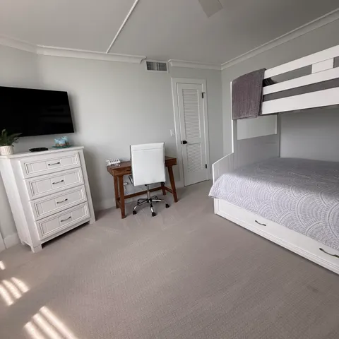 a bedroom with furniture and a flat screen tv