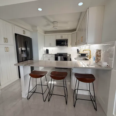 a kitchen with stainless steel appliances a stove a sink and a microwave